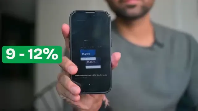 A phone held up to camera showing the Wint app, with a green "9 - 12%" badge over it.